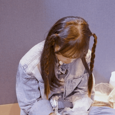 A Girl With Pigtails Is Wearing A Denim Jacket That Says ' Denim ' On The Sleeve GIF