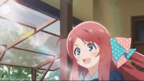 A Girl With Pink Hair And A Blue Bow In Her Hair Is Smiling GIF