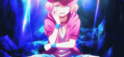 a girl with pink hair and a hat is sitting on the ground with her arms crossed and smiling .