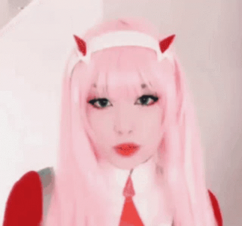 A Girl With Pink Hair And Horns Is Wearing A Pink Wig . GIF