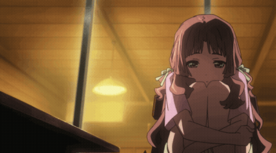 a girl with pink hair is hugging her knees in a dark room