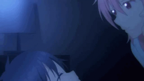 A Girl With Pink Hair Is Laying On A Bed With Her Eyes Closed And A Man Holding Her Hair . GIF