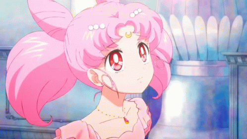 A Girl With Pink Hair Is Wearing A Pink Dress And Necklace GIF