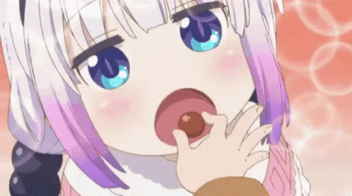 A Girl With Purple Hair And Blue Eyes Is Eating A Donut From Her Hand . GIF