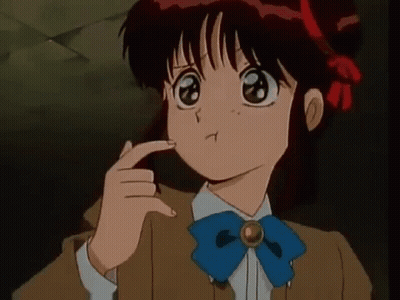 A Girl With Red Hair And A Blue Bow Tie Is Making A Funny Face . GIF