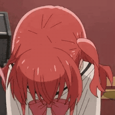 A Girl With Red Hair And A Red Bow Tie Is Bending Over And Praying . GIF