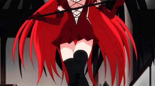 A Girl With Red Hair And Black Thigh High Socks Is Holding A Whip . GIF
