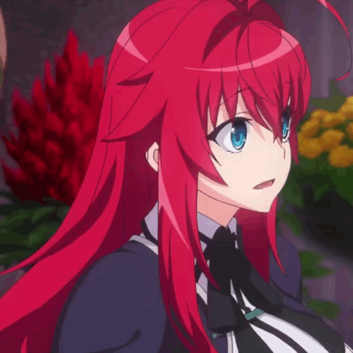 A Girl With Red Hair And Blue Eyes Is Standing In Front Of Flowers GIF
