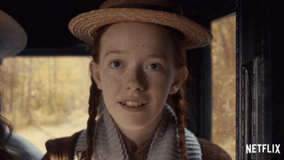 A Girl With Red Hair And Freckles Is Smiling In A Netflix Ad GIF