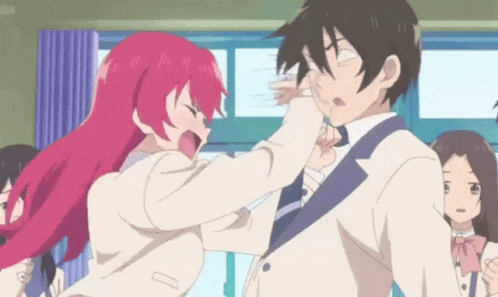 A Girl With Red Hair Is Slapping A Man In A Suit GIF