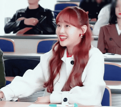 A Girl With Red Hair Is Smiling In A Classroom With Chung Written On The Bottom Left GIF