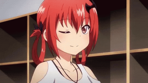 A Girl With Red Hair Is Standing In Front Of A Shelf And Making A Face . GIF