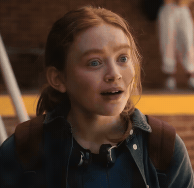 A Girl With Red Hair Is Wearing A Backpack And Headphones GIF