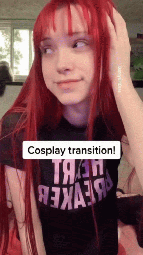 A Girl With Red Hair Is Wearing A Black Shirt That Says " Cosplay Transition " GIF
