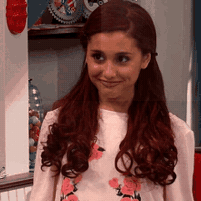 A Girl With Red Hair Is Wearing A Pink Shirt With Flowers On It GIF