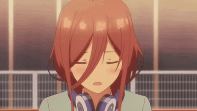 A Girl With Red Hair Is Wearing Headphones And Making A Face . GIF