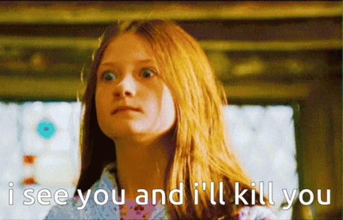 A Girl With Red Hair Says " I See You And I 'Ll Kill You " In Front Of A Window GIF
