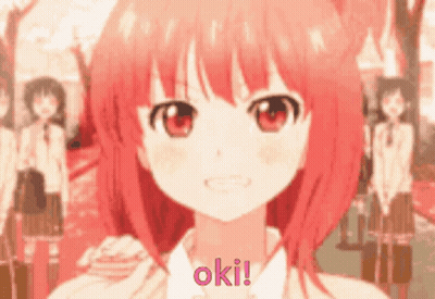 A Girl With Red Hair Says Oki In Front Of A Crowd Of People GIF