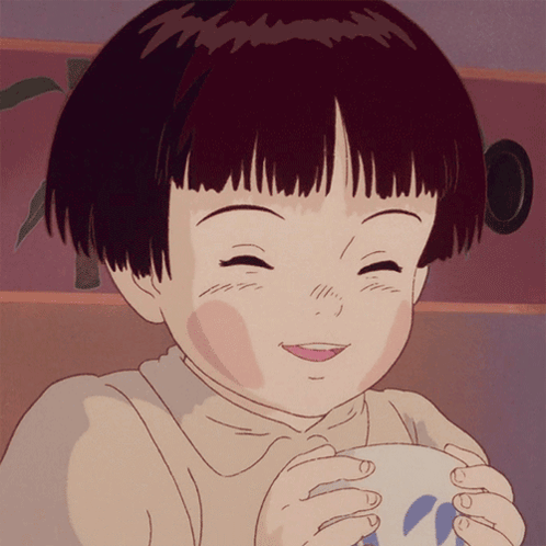 A Girl With Short Hair Is Smiling While Holding A Cup GIF
