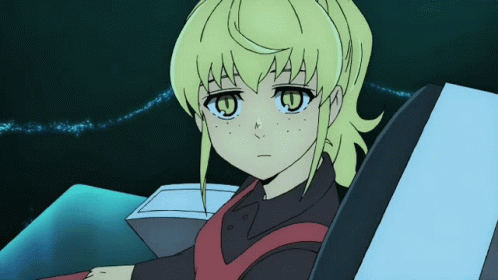 A Girl With Yellow Hair And Green Eyes Is Sitting In A Chair GIF