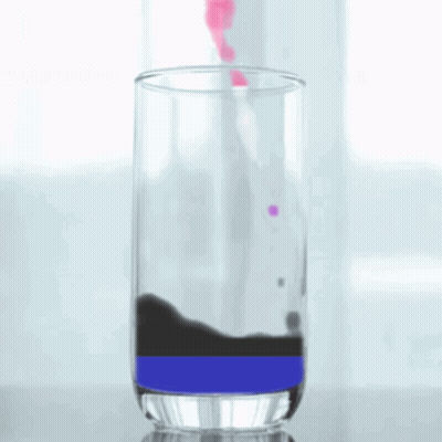 A Glass Filled With A Purple And Black Liquid GIF