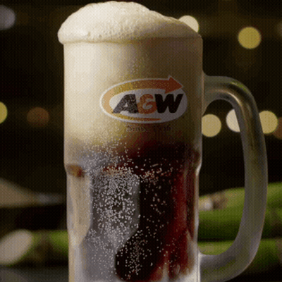 A Glass Mug Of A & W Beer With Foam On Top GIF