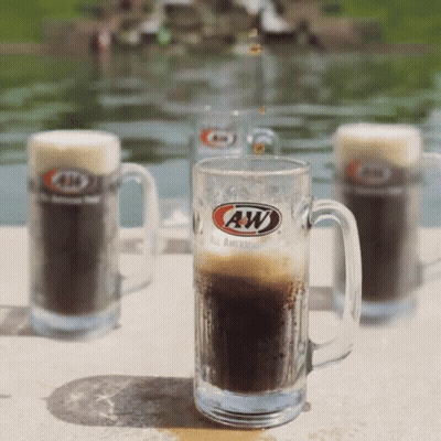 A Glass Of A&w Beer Sits On A Patio GIF