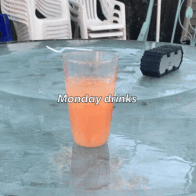 a glass of orange liquid on a table with the words monday drinks