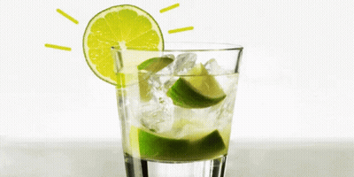 A Glass Of Water With Ice And Lime Slices In It GIF