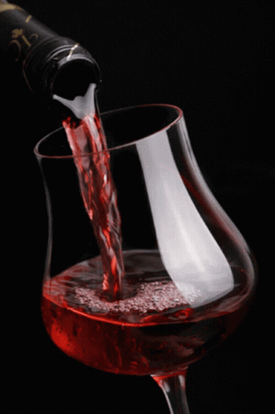 A Glass Of Wine Is Being Poured From A Bottle That Says Clc On It GIF