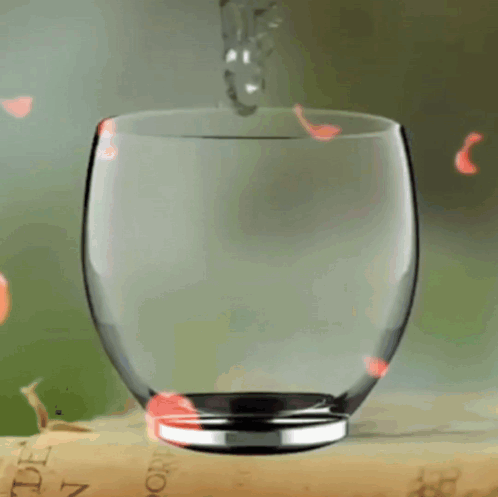 A Glass Sitting On Top Of A Book That Says ' Tomorrow ' GIF