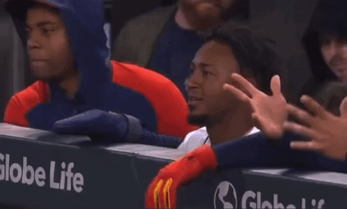 A Globe Life Sign Is Behind A Man GIF