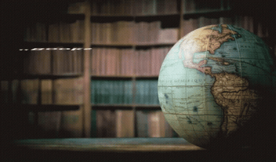 A Globe Sits On A Table Next To A Quote From Stephen King GIF
