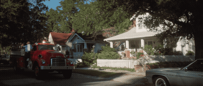 A Gmc Fire Truck Is Parked In Front Of A House GIF