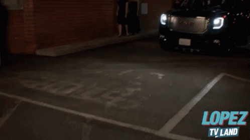 A Gmc Suv Is Parked In A Dark Parking Lot With The Words Lopez Tv Land Written On The Bottom GIF