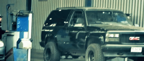 A Gmc Truck Is Parked In A Garage GIF