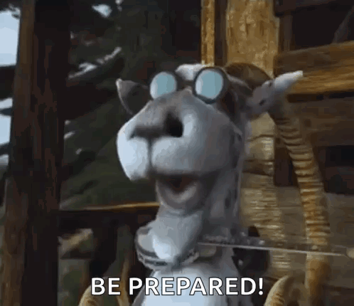 A Goat Wearing Glasses Is Standing In Front Of A Wooden Fence . GIF