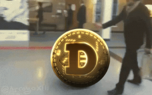 A Gold Coin With The Letter D On It Is Being Pushed By A Man GIF