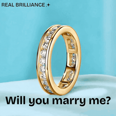 A Gold Ring With The Words " Will You Marry Me " On It GIF