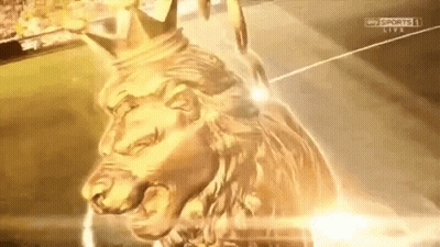 A Gold Statue Of A Lion With A Crown On It GIF