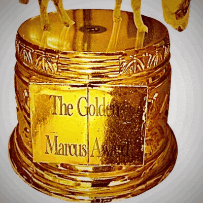 A Gold Trophy With A Sign That Says The Golden Marcus Award GIF