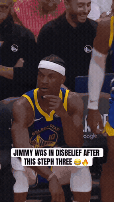 a golden state warriors basketball player sitting in the stands