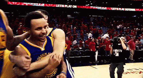 A Golden State Warriors Player Is Being Hugged By Another Player GIF