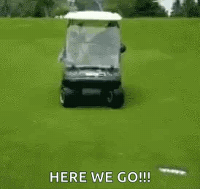 A Golf Cart Is Driving Down A Golf Course With A Person Sitting On The Back . GIF
