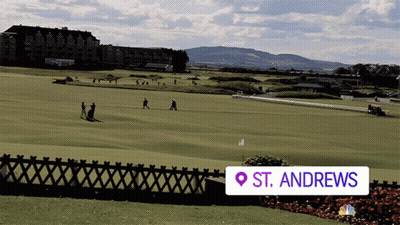 A Golf Course In St. Andrews Is Shown With A Fence In The Foreground GIF