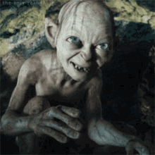A Gollum From The Lord Of The Rings Is Smiling GIF
