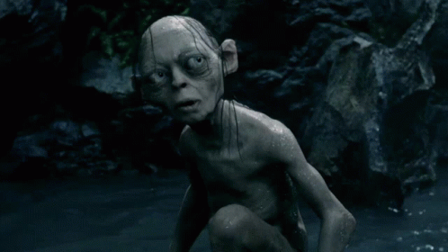 A Gollum Is Crawling In The Water And Looking At The Camera With A Surprised Look On His Face GIF