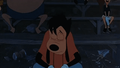A Goofy Cartoon Character Is Sitting On The Ground With His Hands On His Face GIF