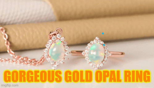 A Gorgeous Gold Opal Ring Sits On A Green Stem GIF