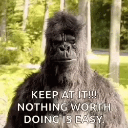 A Gorilla Is Standing In The Woods With The Words `` Keep At It ! Nothing Worth Doing Is Easy . '' . GIF